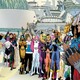 Superboy and Saturn Girl appear before the cheering Legion of Super-Heroes.
